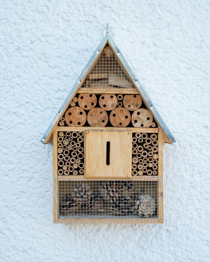 A house-formed bug hotel, Bee or Bug Hotel. Bamboo and other wood and sticks of various diameters stacked into different segments.